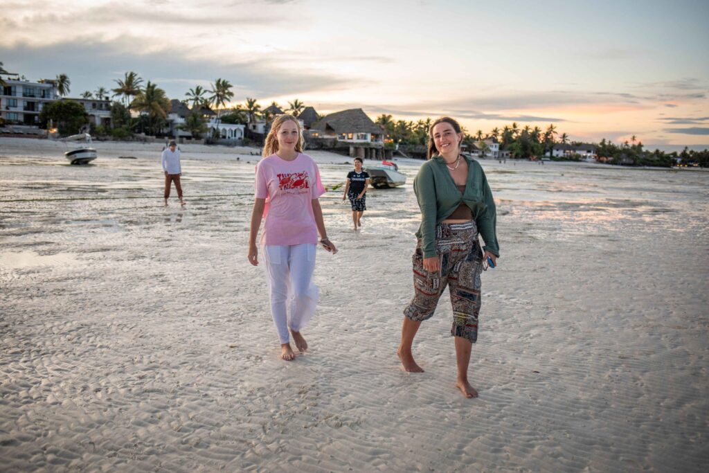 Girls walking on the beach, Zanzibar