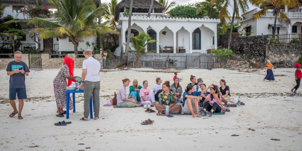 Travellers on the beach, Zanzibar having a dinner
