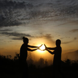 Two travellers infront of a sunset sky in Borneo