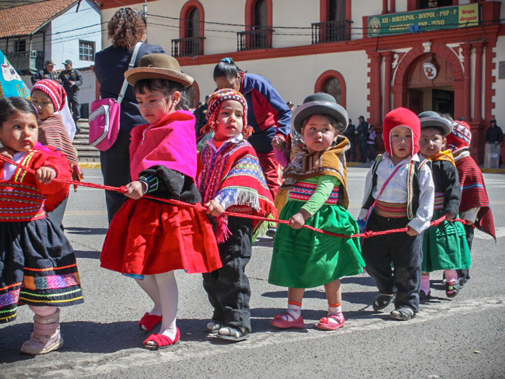 small local children in Peru dressed in traditional clothing