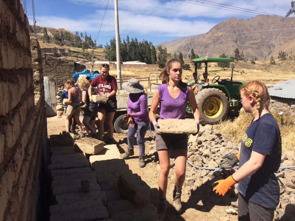 Student travellers working on a project in Peru